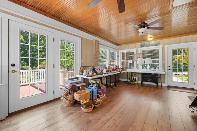 a front view of a house with porch and garden