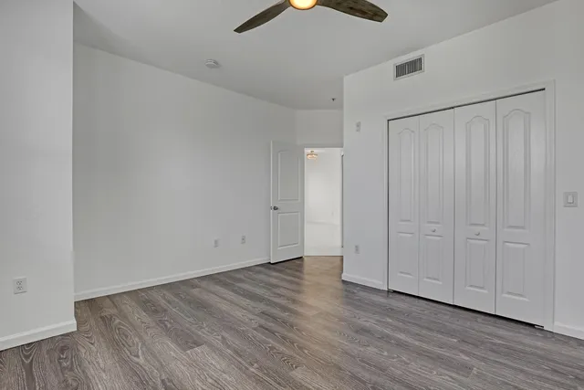 a view of an empty room with wooden floor