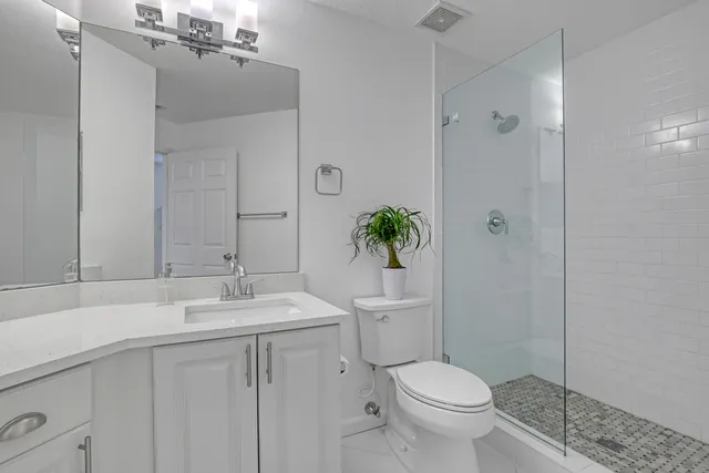a bathroom with a toilet sink and shower