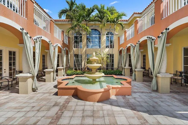 a view of a patio with swimming pool and furniture