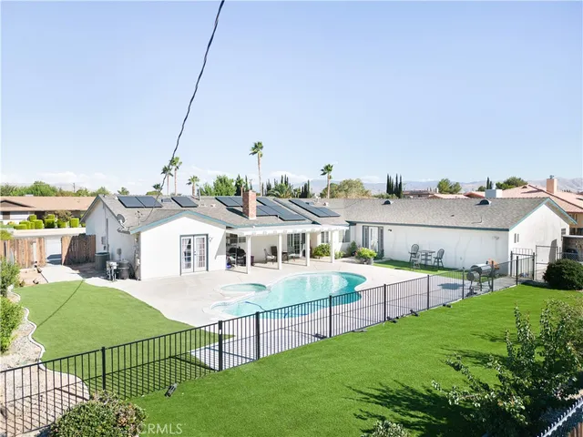 a view of a house with a backyard and porch