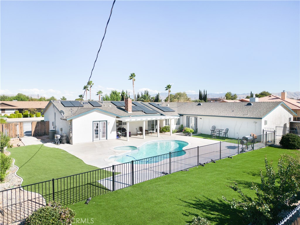 a view of a house with a backyard and porch