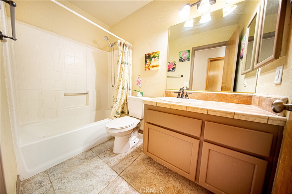 14024 Delaware Road Apple Valley, CA 92307 - Photo 13 of 41 a bathroom with a sink a toilet and shower