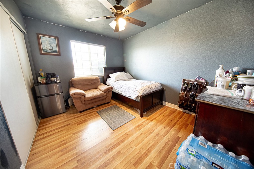 14024 Delaware Road Apple Valley, CA 92307 - Photo 14 of 41 a bedroom with double bed and a chandelier