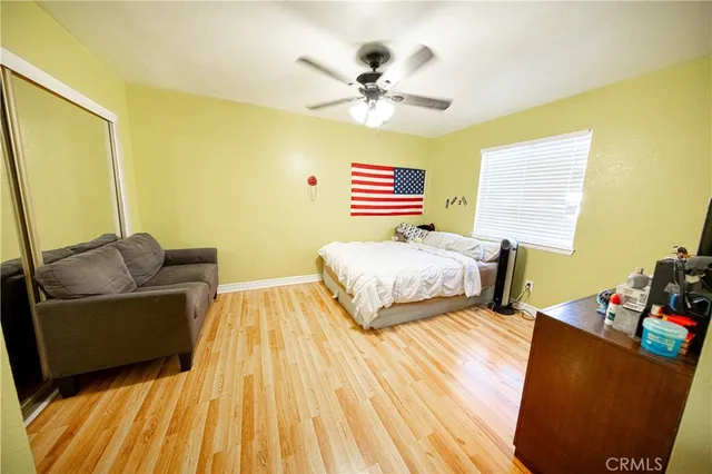 a bedroom with a bed and wooden floor
