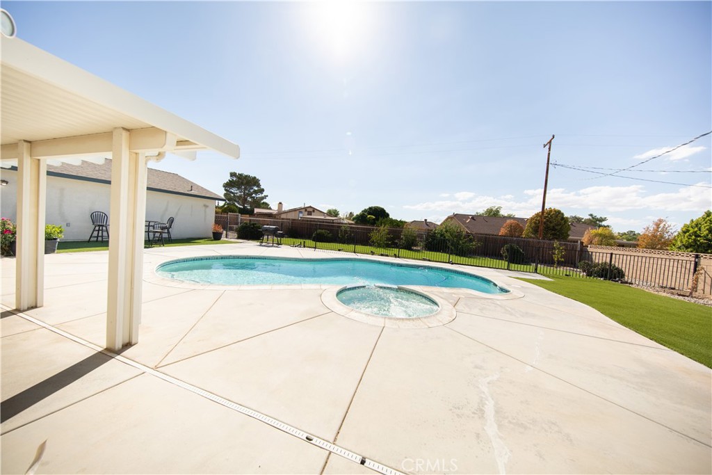 14024 Delaware Road Apple Valley, CA 92307 - Photo 19 of 41 a view of a swimming pool with a yard