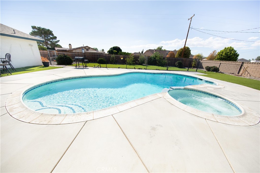 14024 Delaware Road Apple Valley, CA 92307 - Photo 20 of 41 a view of a swimming pool with a yard