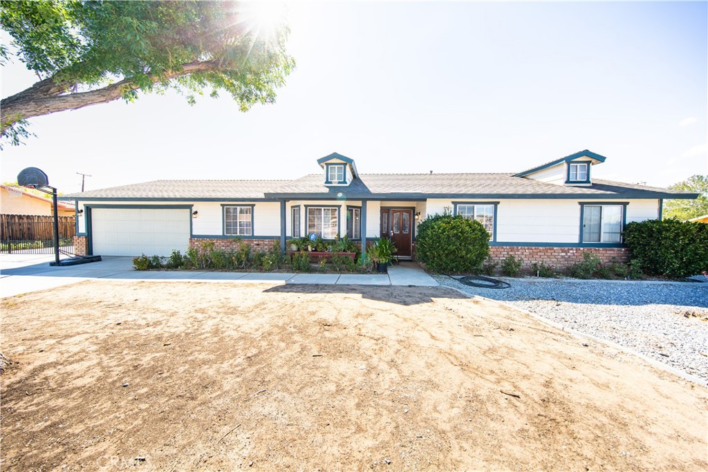 14024 Delaware Road Apple Valley, CA 92307 - Photo 2 of 41 a front view of a house with garden