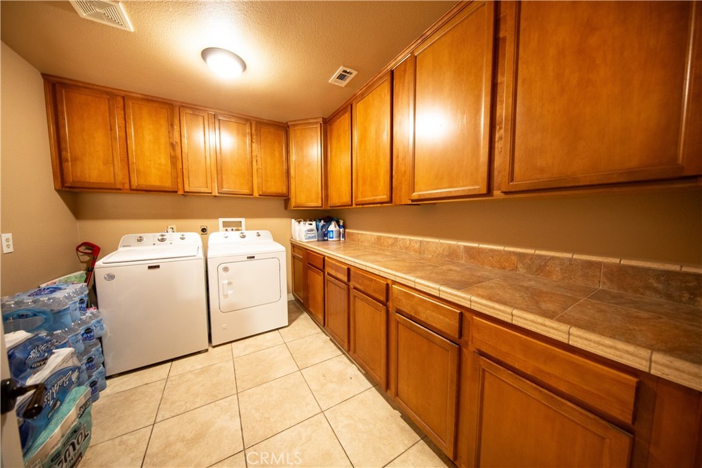 14024 Delaware Road Apple Valley, CA 92307 - Photo 23 of 41 a view of a kitchen with cabinets and wooden floor