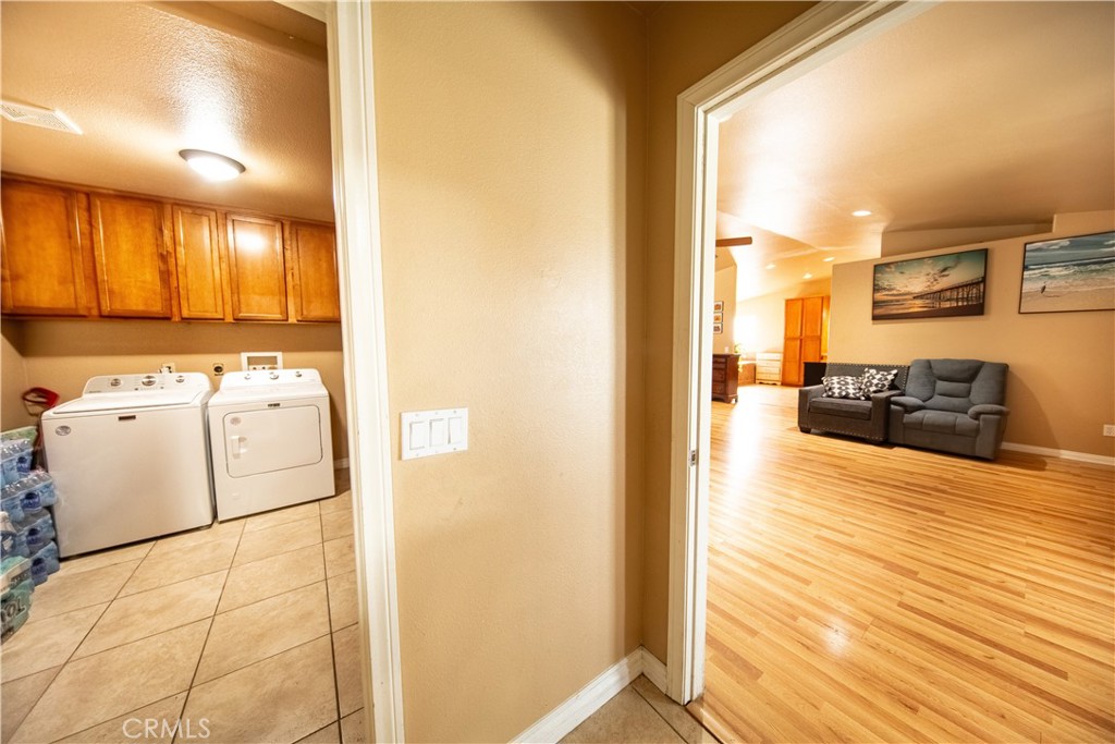 14024 Delaware Road Apple Valley, CA 92307 - Photo 24 of 41 a view of washer and dryer with kitchen in the background