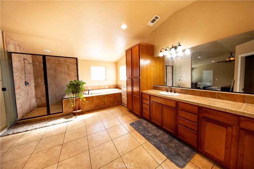 14024 Delaware Road Apple Valley, CA 92307 - Photo 28 of 41 a large bathroom with a double vanity sink and a mirror