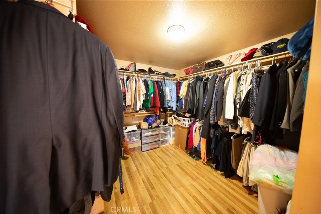 14024 Delaware Road Apple Valley, CA 92307 - Photo 29 of 41 a view of walk in closet with clothes