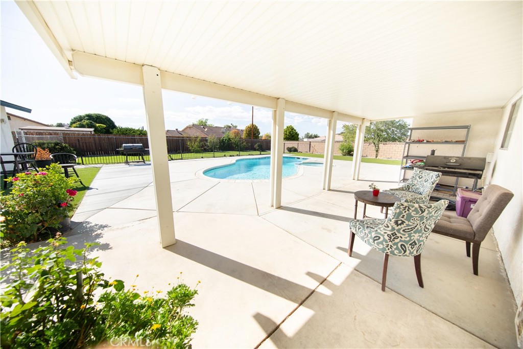 14024 Delaware Road Apple Valley, CA 92307 - Photo 32 of 41 a living room with patio furniture and a floor to ceiling window