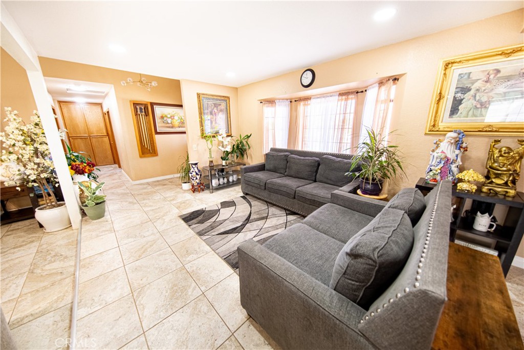14024 Delaware Road Apple Valley, CA 92307 - Photo 9 of 41 a living room with furniture and a large window