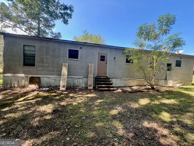a view of a house with a snow on the road
