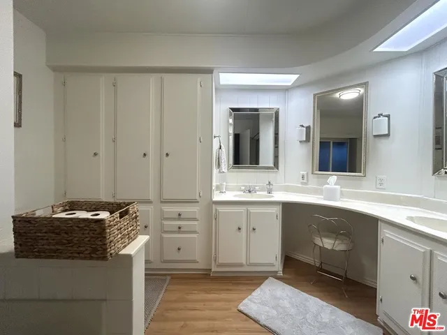 a living room with dining table and a flat screen tv