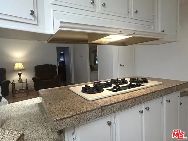 a spacious bedroom with a bed and a television