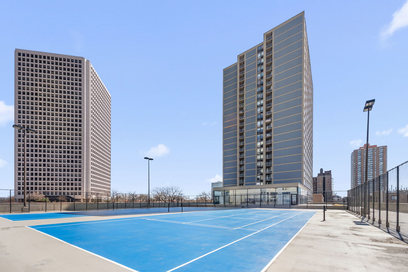 5320 North Sheridan Road, Unit 2201 Chicago, IL 60640 - Photo 16 of 18 a view of a tall building next to a yard