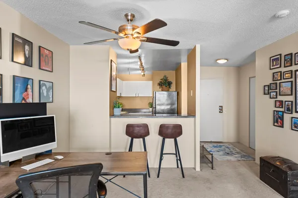 a view of a workspace with furniture and a flat screen tv