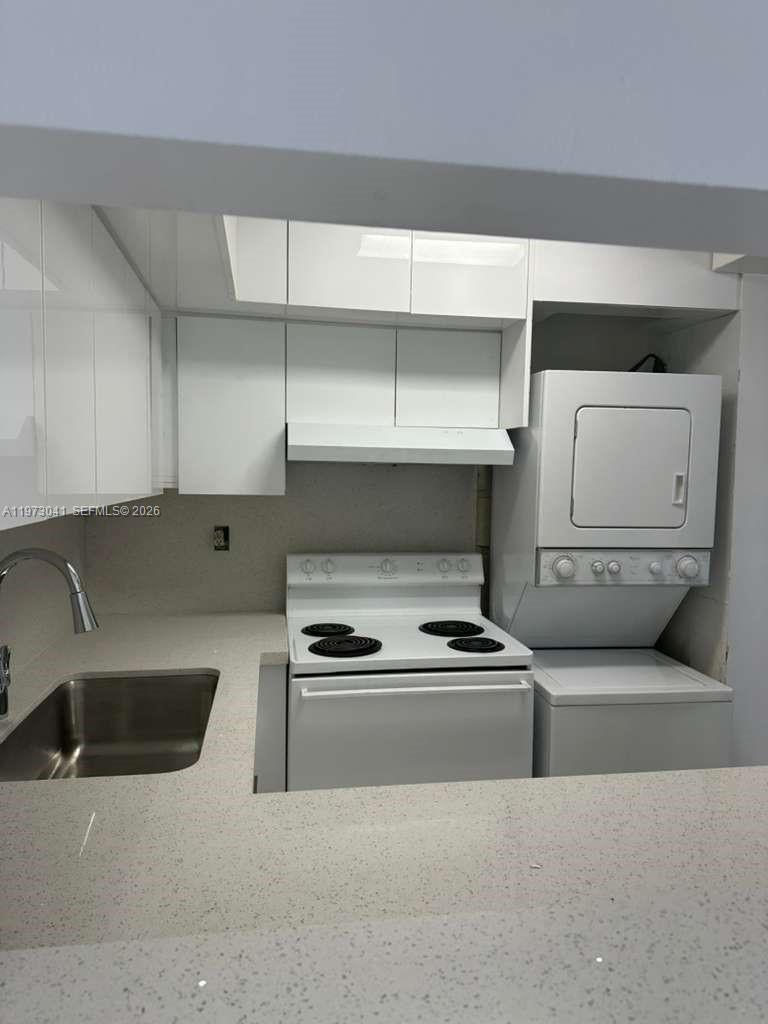 13810 Southwest 112th Street, Unit 110 Miami, FL 33186 - Photo 4 of 11 a kitchen that has a sink and a stove