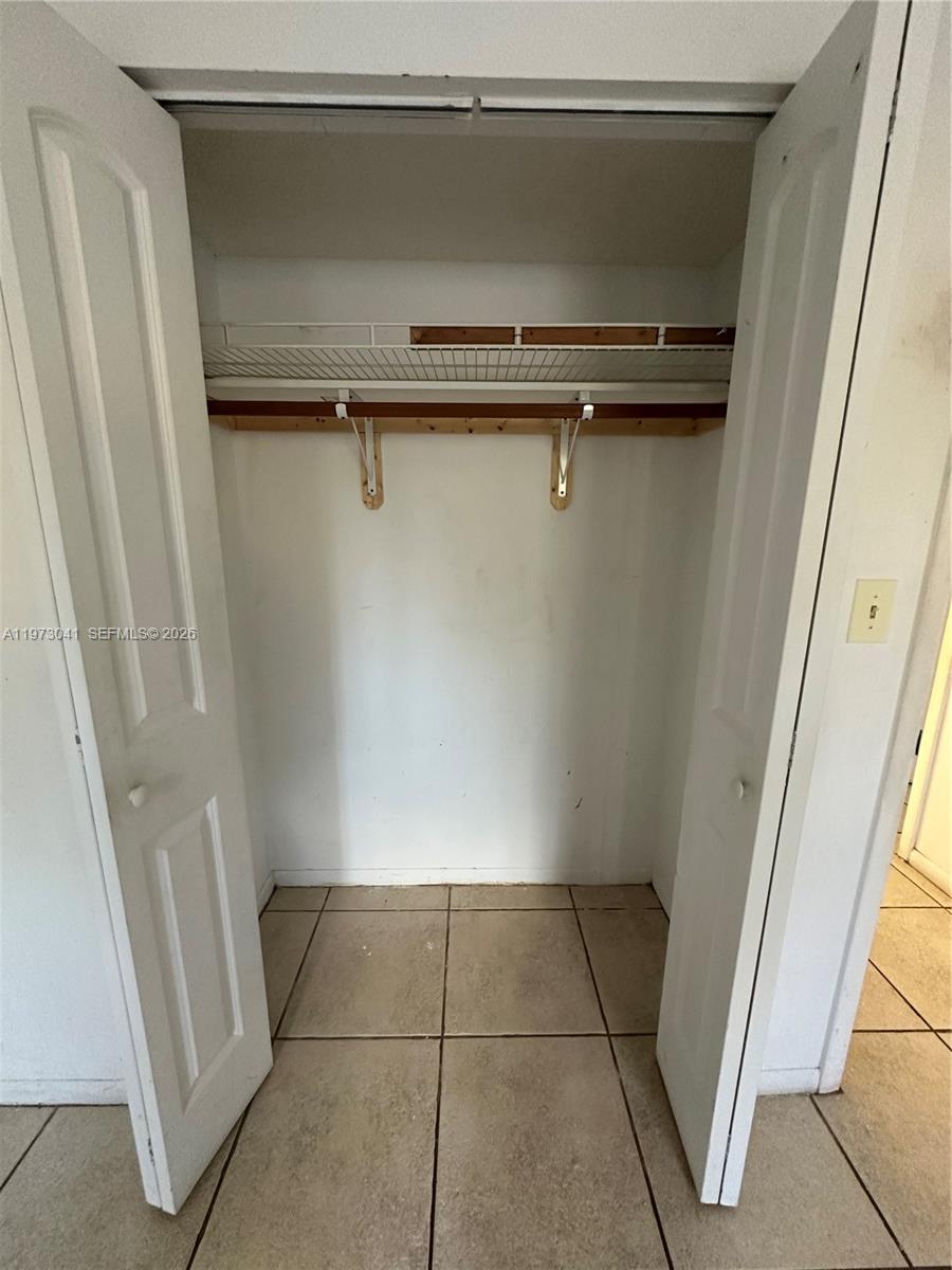 13810 Southwest 112th Street, Unit 110 Miami, FL 33186 - Photo 7 of 11 a view of a room with an empty space and a window