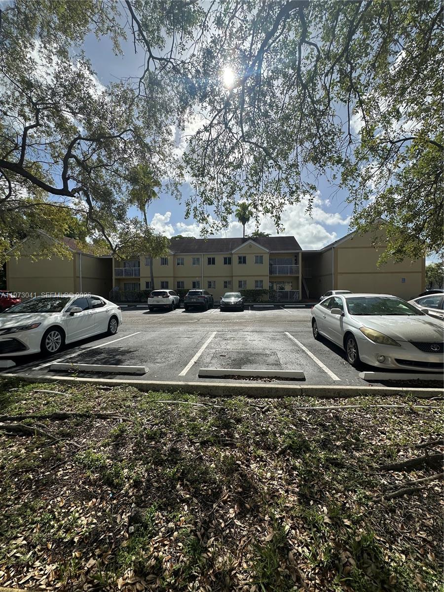 13810 Southwest 112th Street, Unit 110 Miami, FL 33186 - Photo 9 of 11 a view of car parked on the side of a road