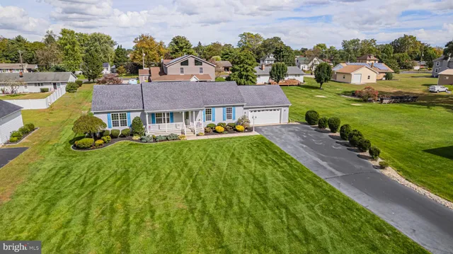 a aerial view of a house with garden space and street view