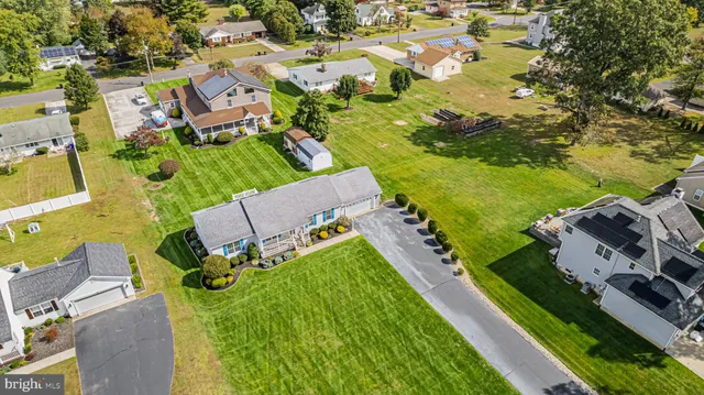 an aerial view of multiple houses with yard
