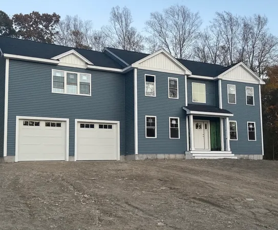 a front view of a house with yard and garage