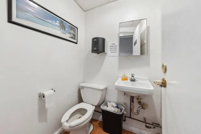 a white toilet sitting next to a bathroom sink
