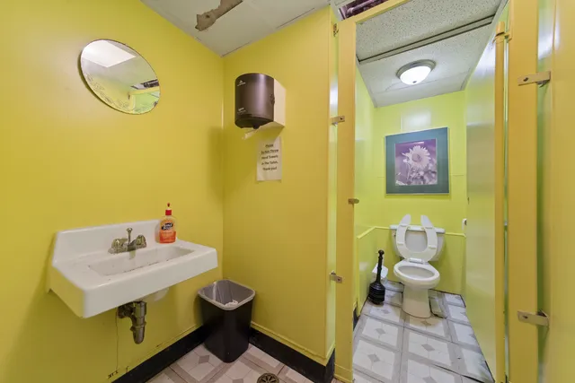 a bathroom with a sink mirror vanity and toilet
