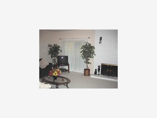 100 East Middlefield Road, Unit 6F Mountain View, CA 94043 - Photo 3 of 9 a living room with furniture and flowers