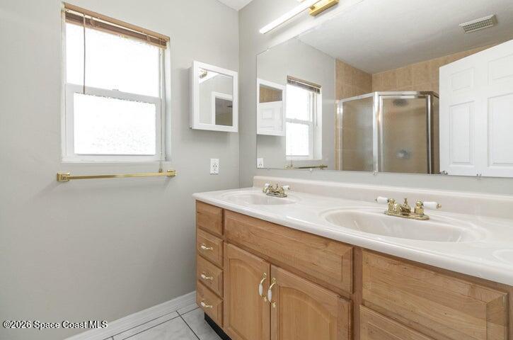 2595 3rd Avenue Northeast Palm Bay, FL 32905 - Photo 12 of 17 a bathroom with a sink and a mirror