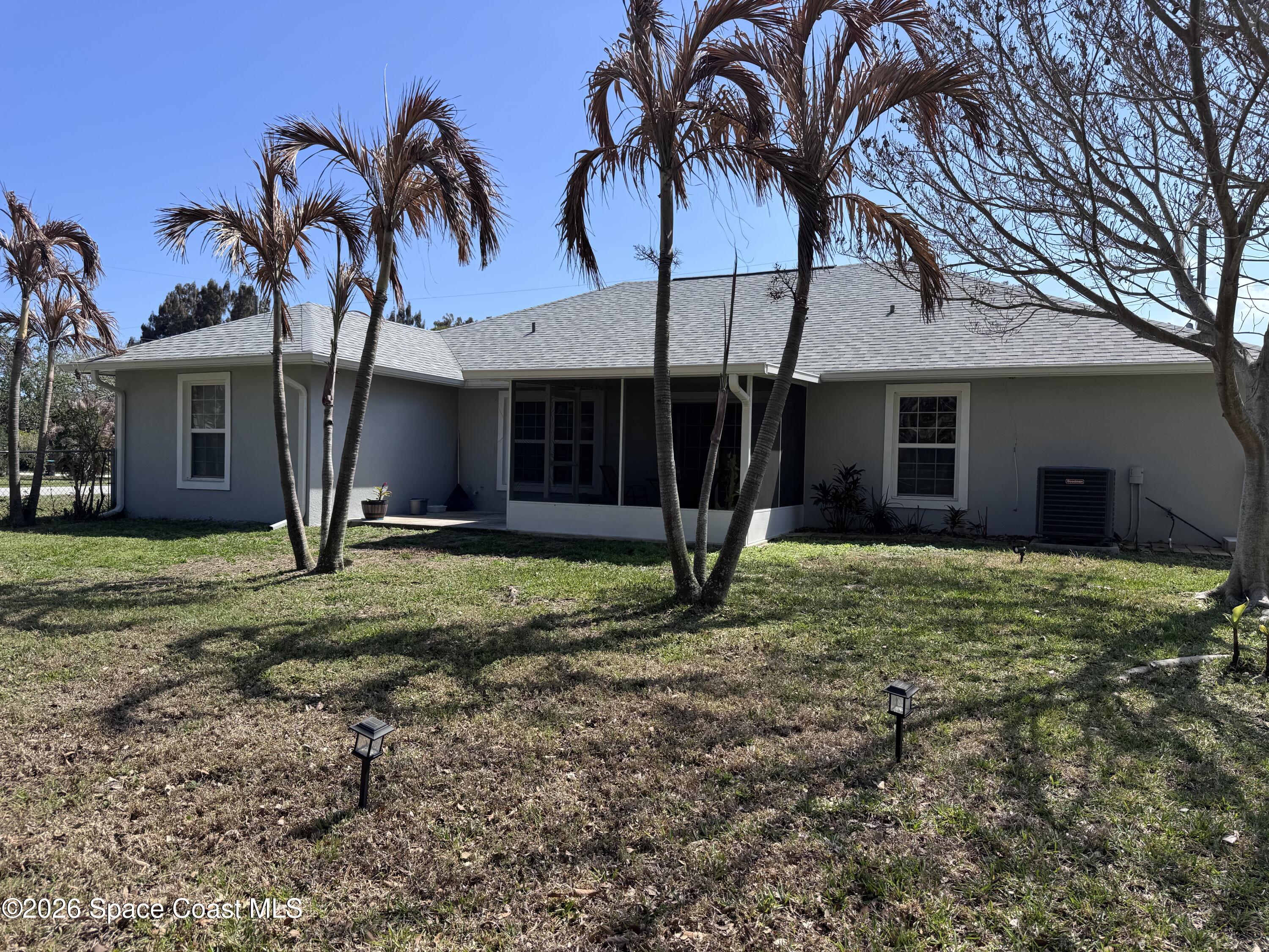 2595 3rd Avenue Northeast Palm Bay, FL 32905 - Photo 17 of 17 a view of a house with a yard and palm trees