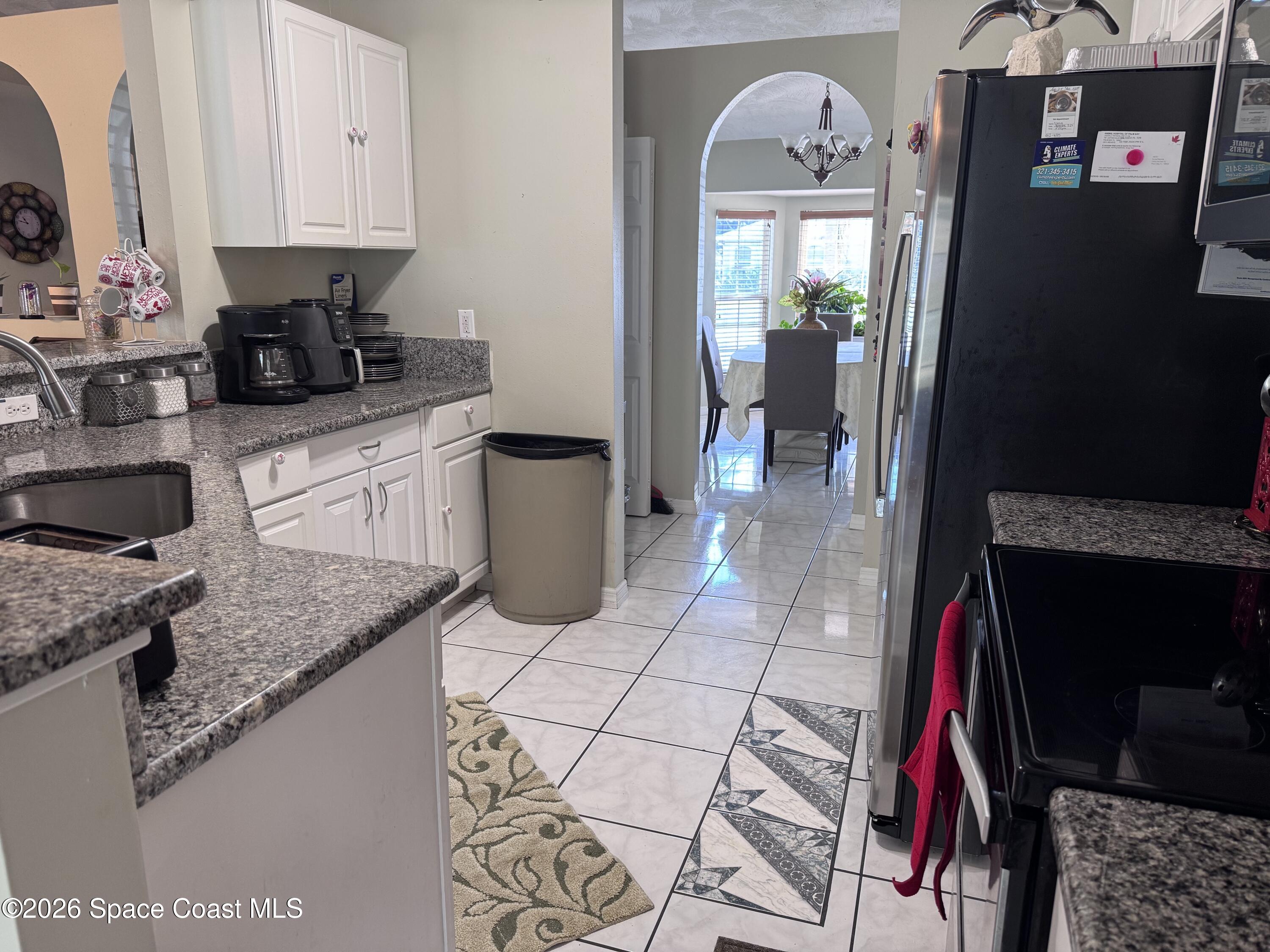 2595 3rd Avenue Northeast Palm Bay, FL 32905 - Photo 7 of 17 a kitchen with a sink a stove and cabinets