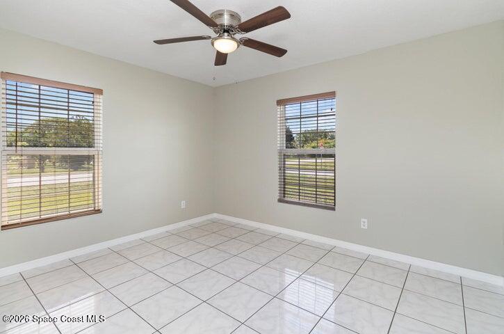2595 3rd Avenue Northeast Palm Bay, FL 32905 - Photo 8 of 17 a view of an empty room with a window and a ceiling fan