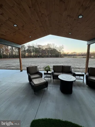 a living room with furniture a large window with outer view