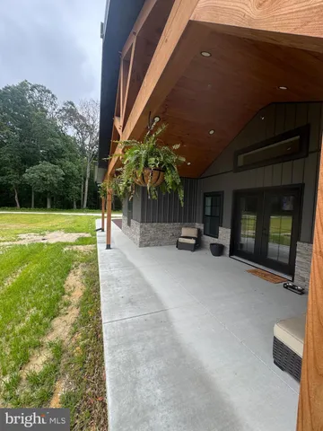 a living room with furniture and large windows