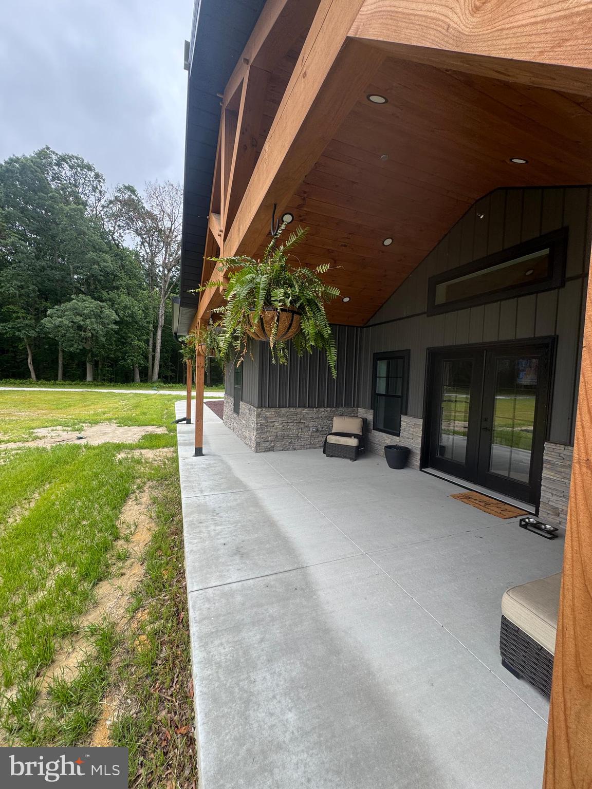 26067 Goldsboro Road Goldsboro, MD 21636 - Photo 8 of 21 a view of a patio with a table and chairs under an umbrella