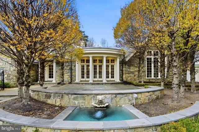 front view of a house with a fountain
