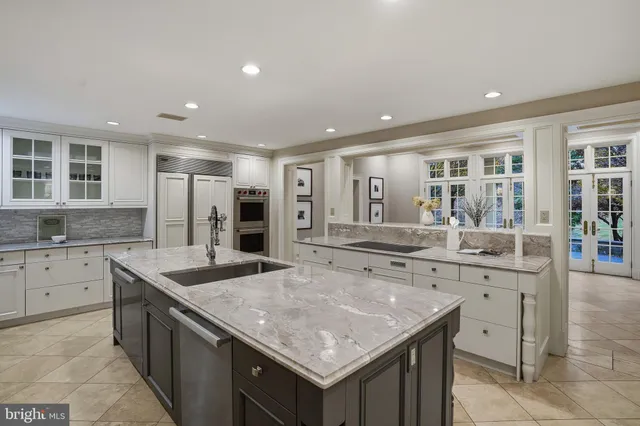 a hallway with a sink and a large mirror