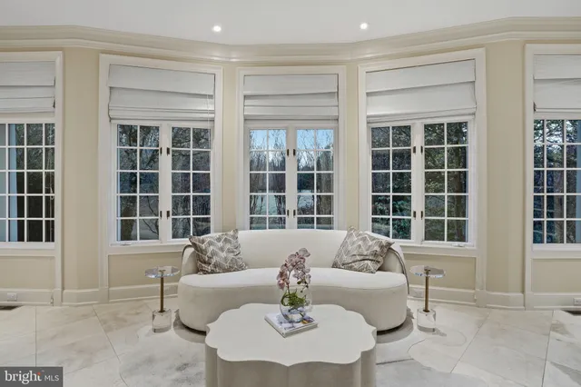 a front view of a house with a garden and trees