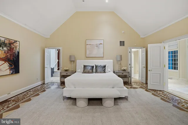 a large bedroom with a bed and fireplace