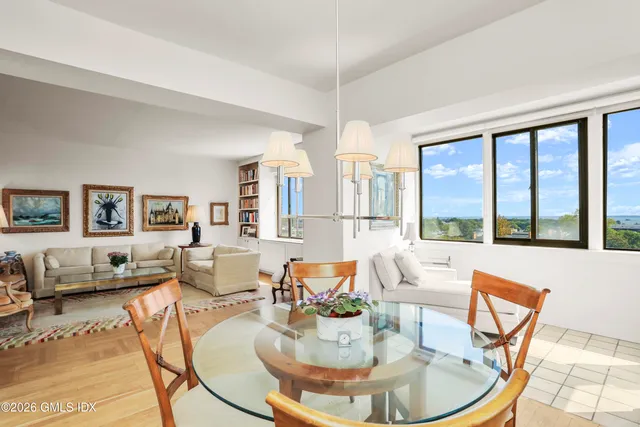 a living room with fireplace furniture and a large window