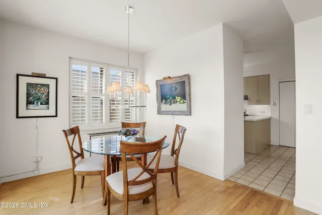 a view of a dining room with furniture and a window