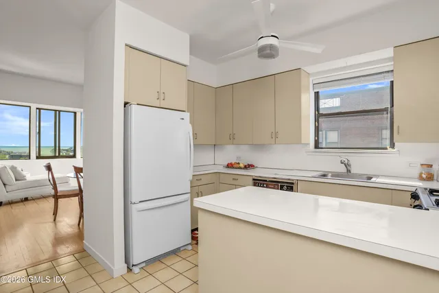 a white refrigerator freezer sitting inside of a kitchen