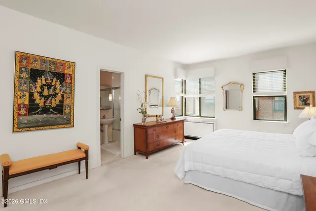 a living room with furniture and a dresser