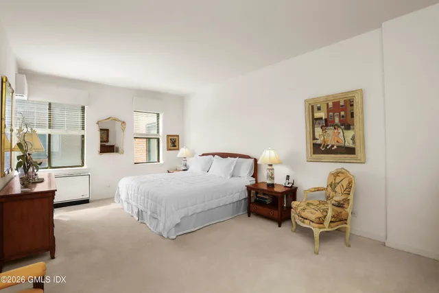 a spacious bedroom with a bed and a couch