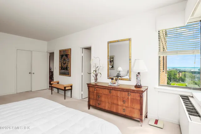 a bedroom with a bed and a dresser in it