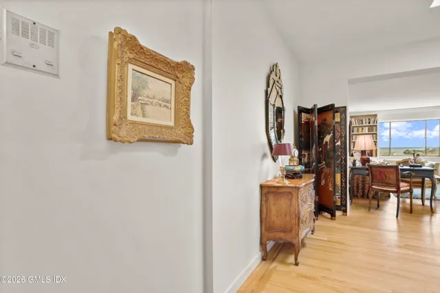 a view of a workspace with furniture and wooden floor